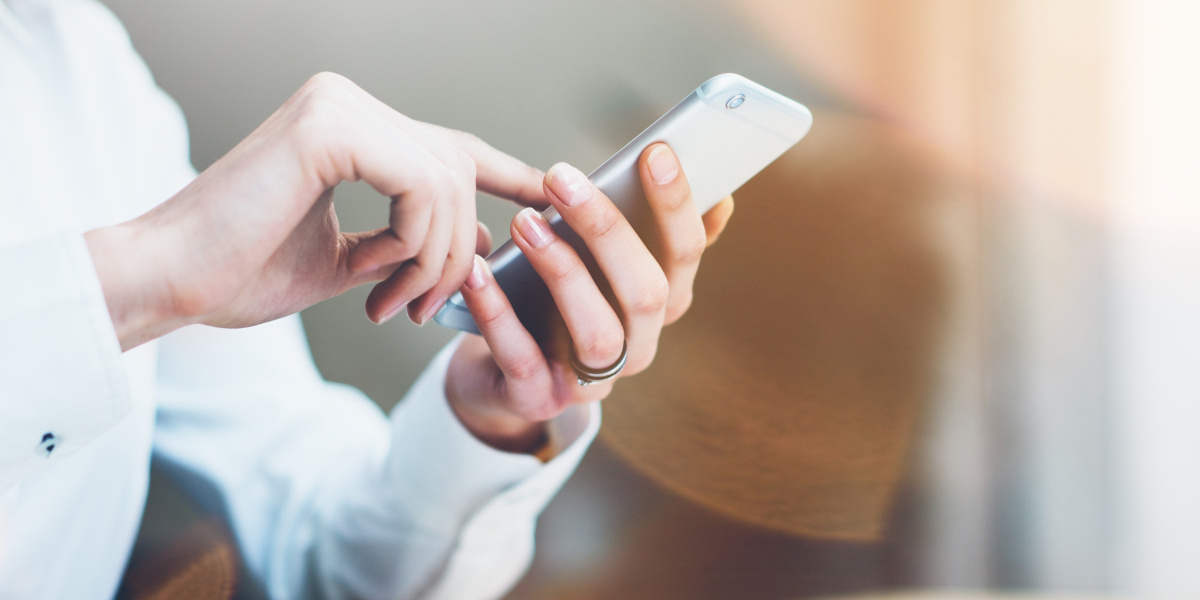 Close Up of Woman's Hands Using Mobile Phone